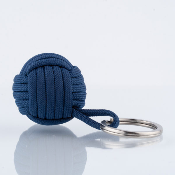 Der Seglerknoten Affenfaust als Schlüsselanhänger aus Paracord in Blau in einer Größe von 3,7cm. Der Anhänger ist mit einem Edelstahlfederring in 32mm Durchmesser für die Schlüssel versehen. Der Anhänger ist handgefertigt in hochwertiger Verarbeitung. Der kleine Helfer für den Alltag. Für Männer als auch für Frauen, die den maritimen Stil lieben. AHOI!