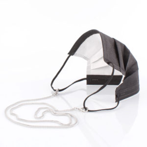 Die Masken Kette aus Edelstahl ist stylisch, edel und zugleich eine effektive Hilfe im Alltag. Hier in silberfarben. Die Panzerkette ist ein Klassiker und findet sich in vielen Accessoires wieder. Zum Beispiel in den Tragriemen von den angesagten Handtaschen. Damit Du nicht ständig Deine Maske aus der Tasche holen musst, oder in der Hand hältst, hängst Du die Maske einfach um den Hals. Die zwei Karabinerverschlüsse klemmst Du einfach an die Maske. Diese Edelstahlkette aus Panzerkettengliedern ist eine zarte Ausführung und ist leicht. Die Panzerkette glitzert durch die facettierten Glieder. Sie sieht wie Silber aus.